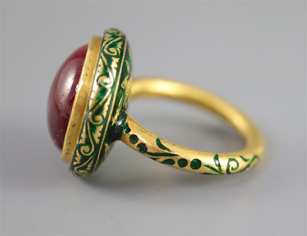 An antique Mogul gold, green enamel and cabochon natural red spinel set ring, size K.